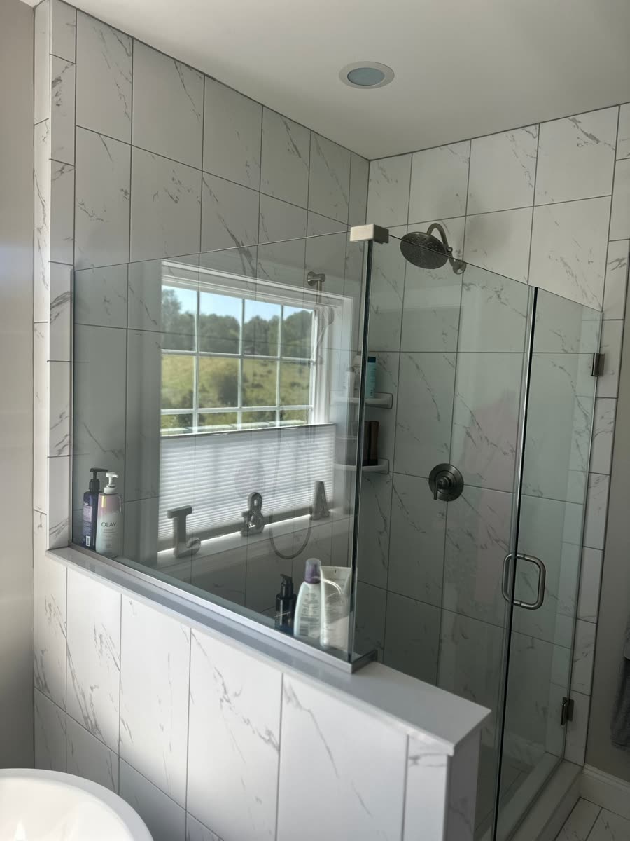 Marble tile bathroom with glass shower enclosure