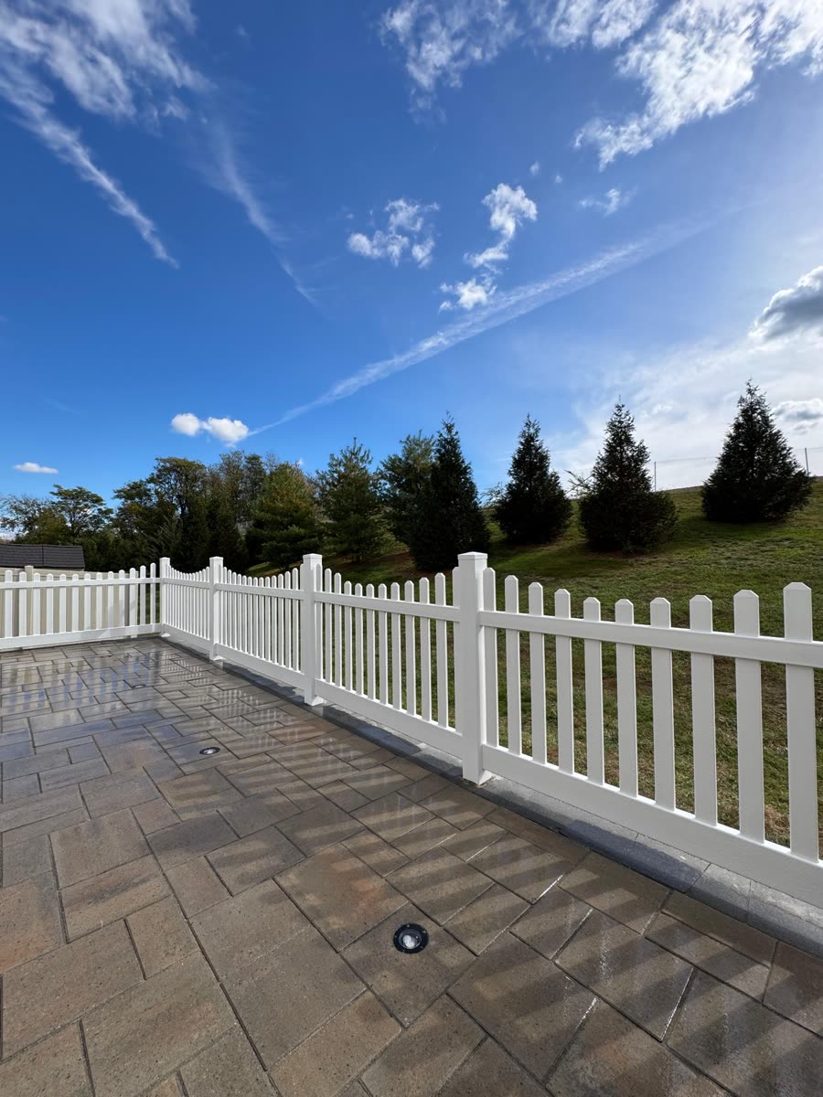 White picket fence with paver patio